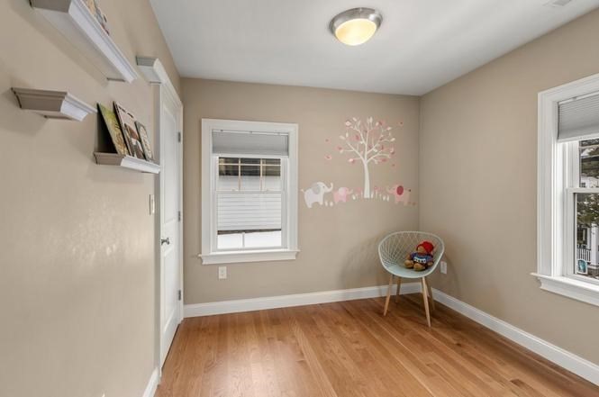 22 Myrtle Street Watertown, MA 02472 - Photo 16 of 18 a view of an empty room with a window and wooden floor