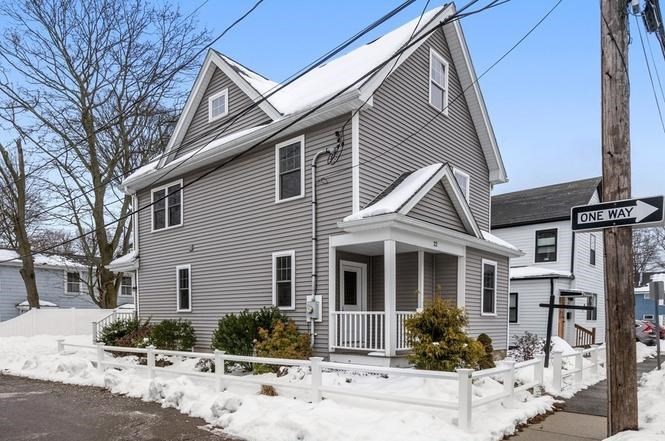 22 Myrtle Street Watertown, MA 02472 - Photo 2 of 18 a front view of a house with a yard