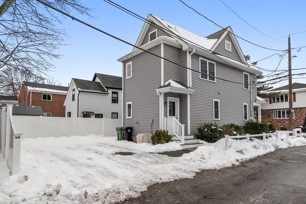 22 Myrtle Street Watertown, MA 02472 - Photo 3 of 18 a view of a white house with snow on the road
