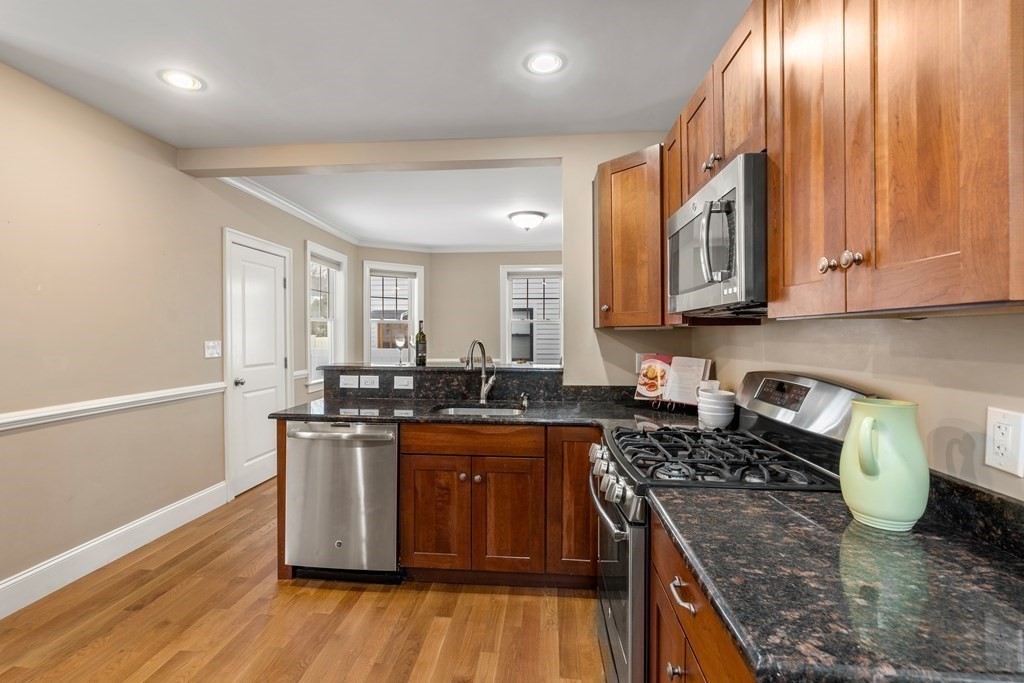 22 Myrtle Street Watertown, MA 02472 - Photo 6 of 18 a kitchen with granite countertop a sink a counter space appliances and cabinets