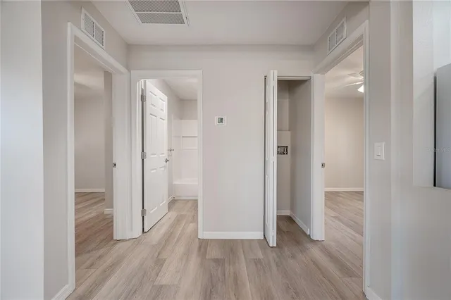 a view of a hallway with wooden floor