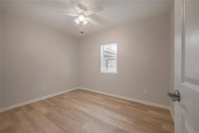 wooden floor in an empty room with a window