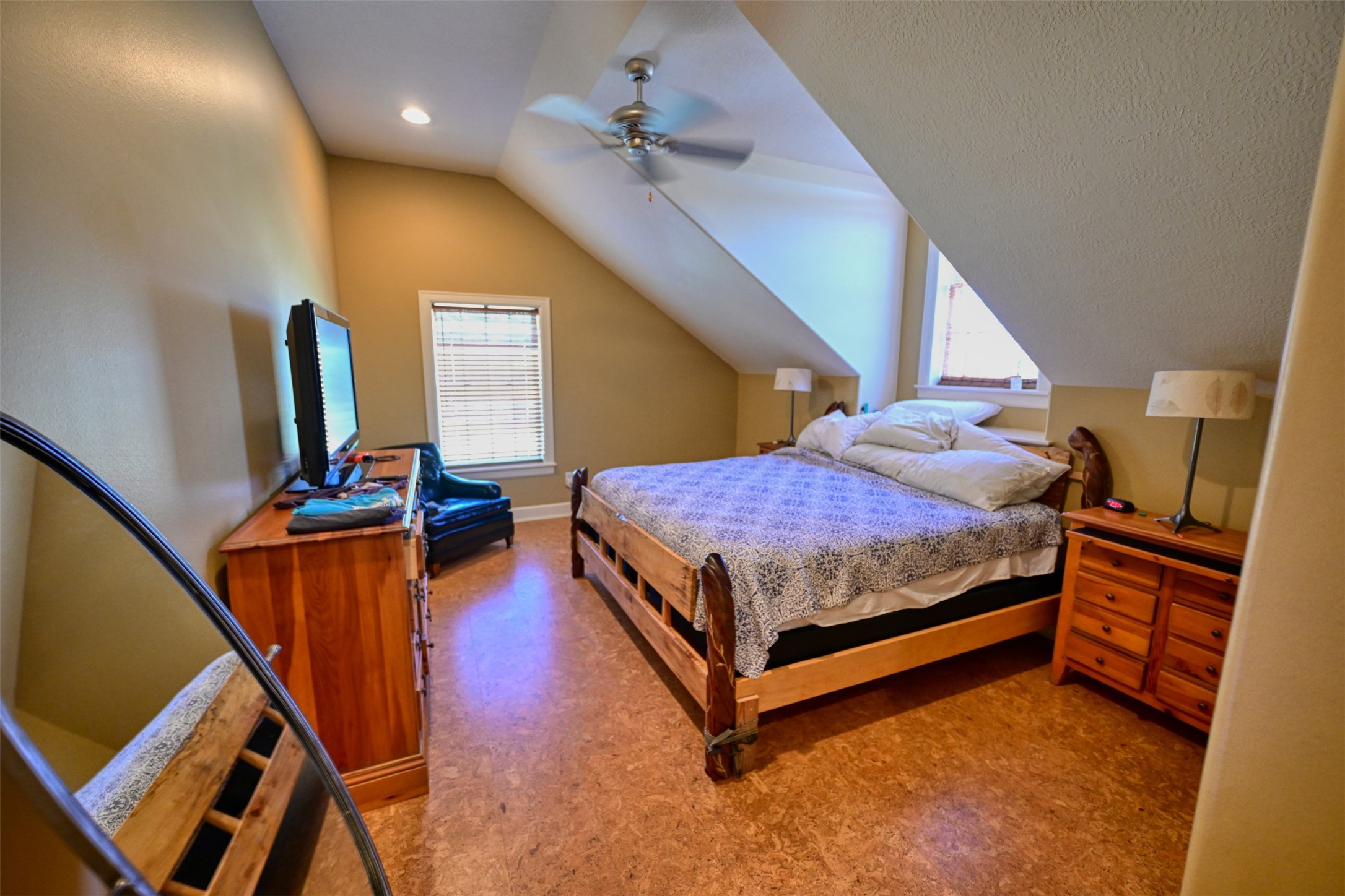 5960 Schoenau Road Brenham, TX 77833 - Photo 15 of 49 a bedroom with a bed and dresser with wooden floor