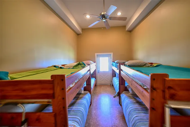 a bedroom with two beds and a chandelier
