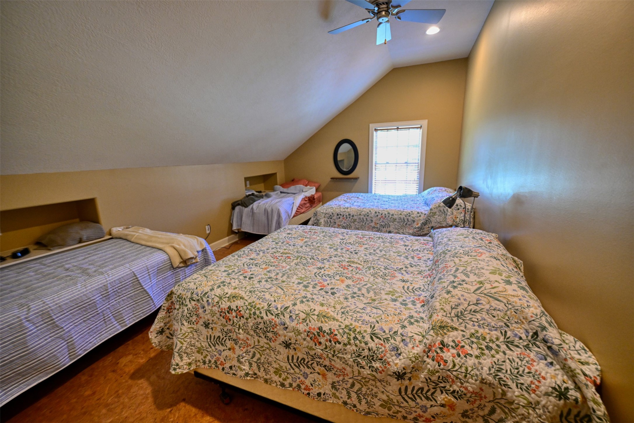 5960 Schoenau Road Brenham, TX 77833 - Photo 17 of 49 a bedroom with two beds and a chandelier
