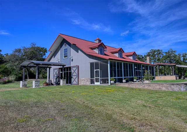 a front view of a house with a yard table and chairs