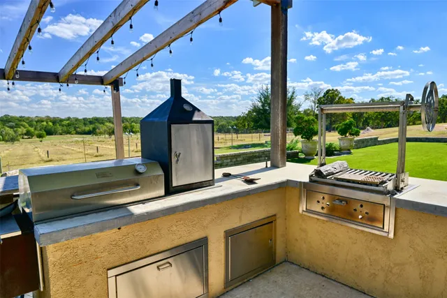 a yard with lots of green space and mountain view in back