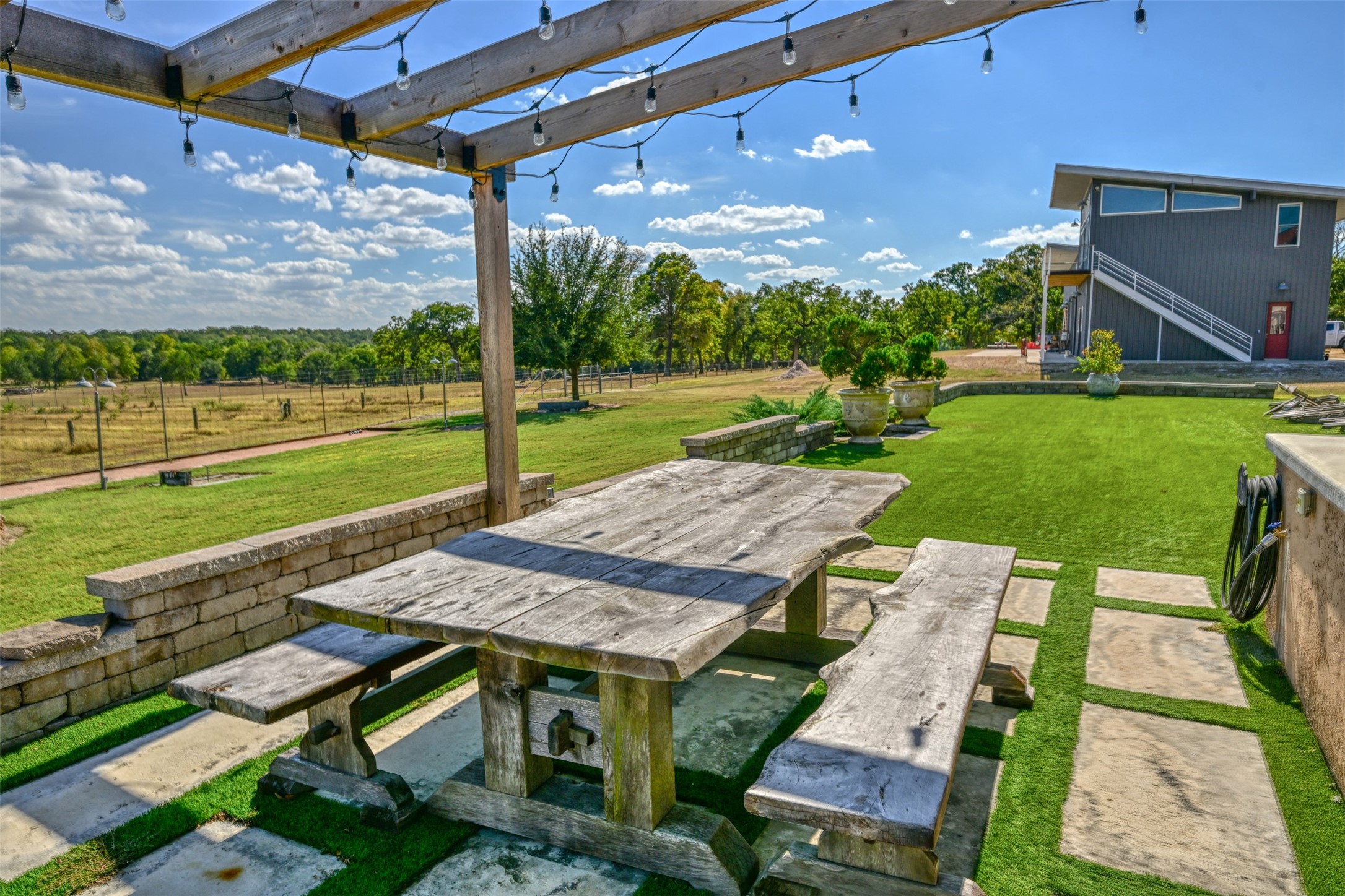 5960 Schoenau Road Brenham, TX 77833 - Photo 22 of 49 a view of a patio with a table chairs and a backyard