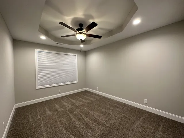 an empty room with a empty space and a ceiling fan
