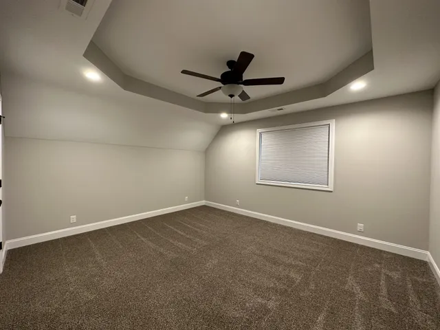 an empty room with a empty space and windows