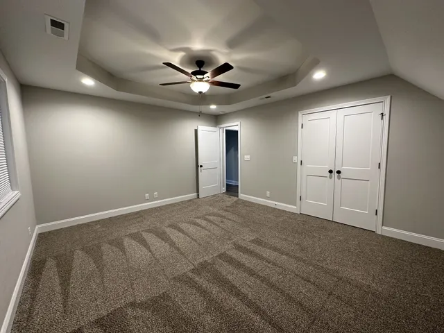 a view of an empty room with a ceiling fan