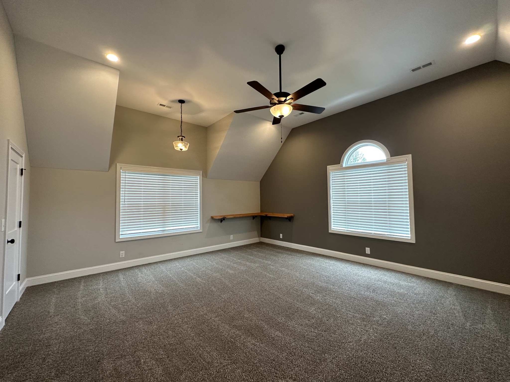 1592 Charles Bell Road Clarksville, TN 37043 - Photo 25 of 30 an empty room with a chandelier fan and windows
