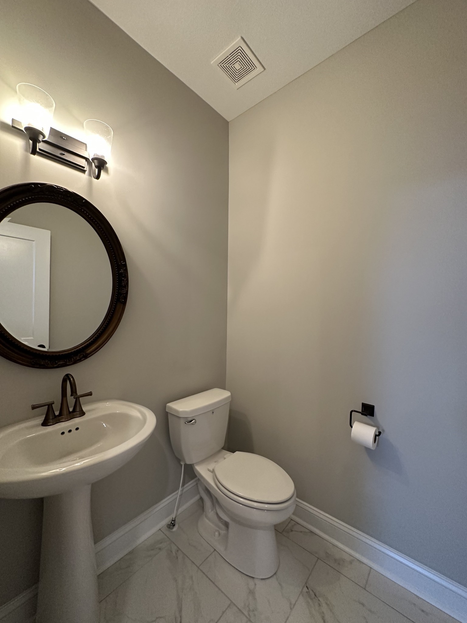 1592 Charles Bell Road Clarksville, TN 37043 - Photo 26 of 30 a bathroom with a toilet a sink and mirror