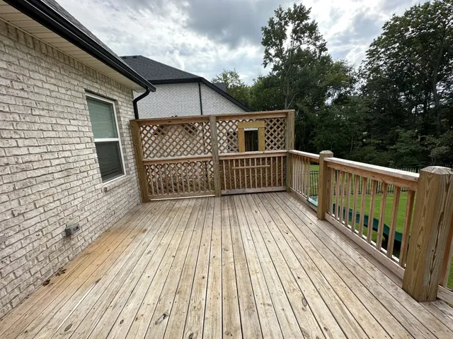 a view of a wooden deck with trees