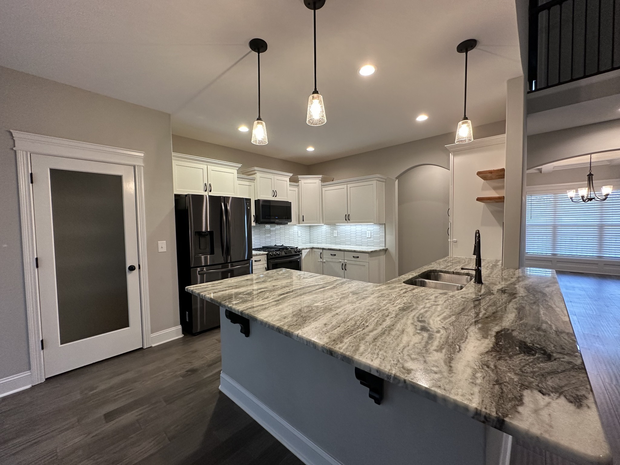 1592 Charles Bell Road Clarksville, TN 37043 - Photo 9 of 30 a large kitchen with kitchen island a large island in it