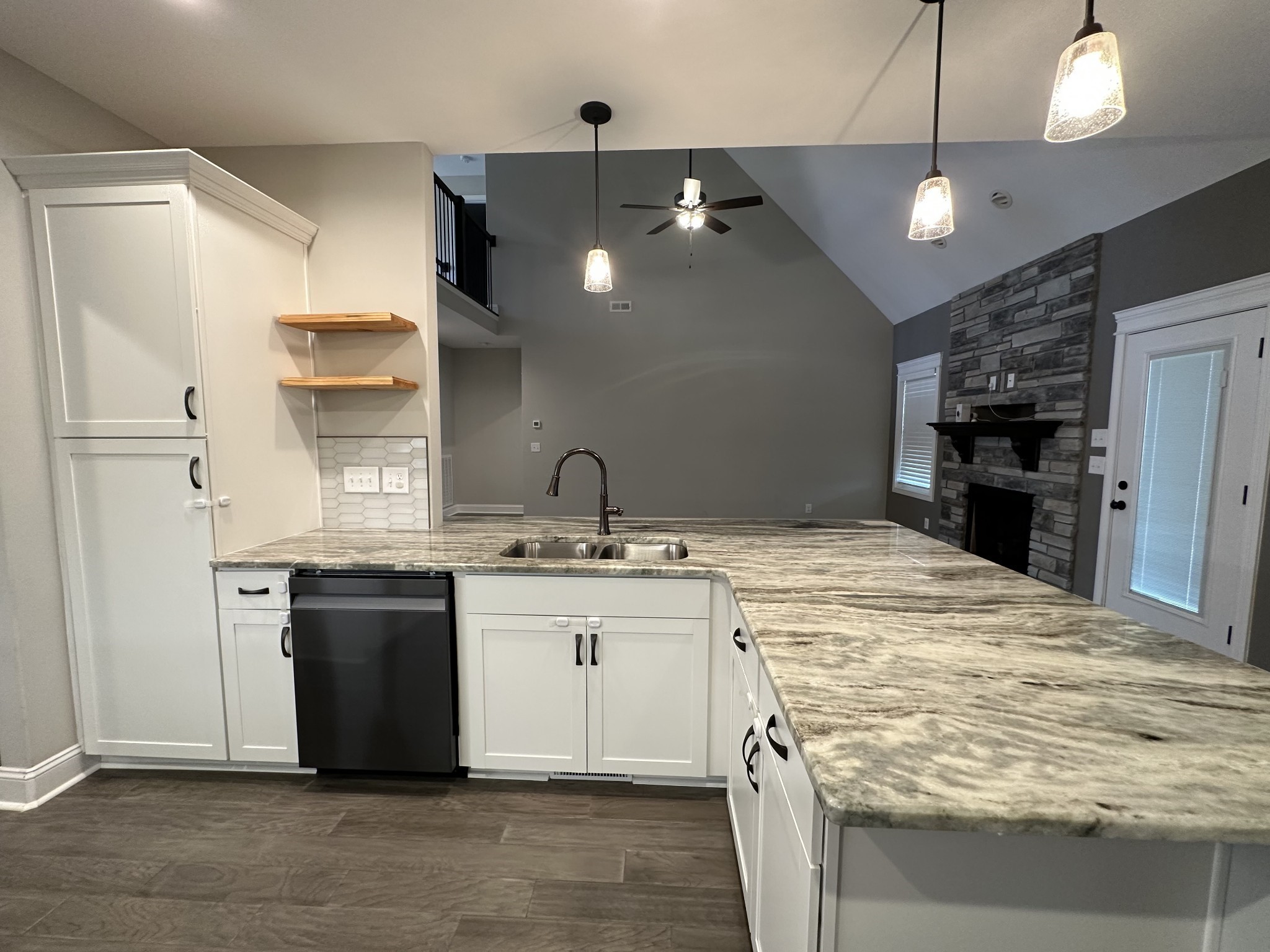 1592 Charles Bell Road Clarksville, TN 37043 - Photo 10 of 30 a kitchen with kitchen island granite countertop a sink cabinets and stainless steel appliances
