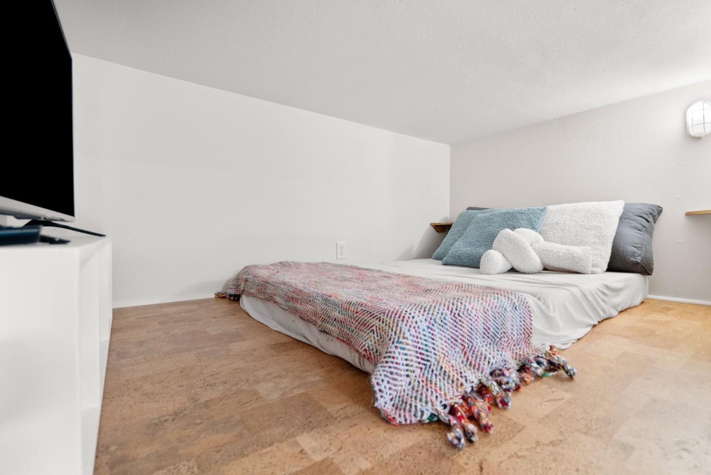 770 Graham Hill Road Santa Cruz, CA 95060 - Photo 69 of 83 a bedroom with a bed and a flat screen tv