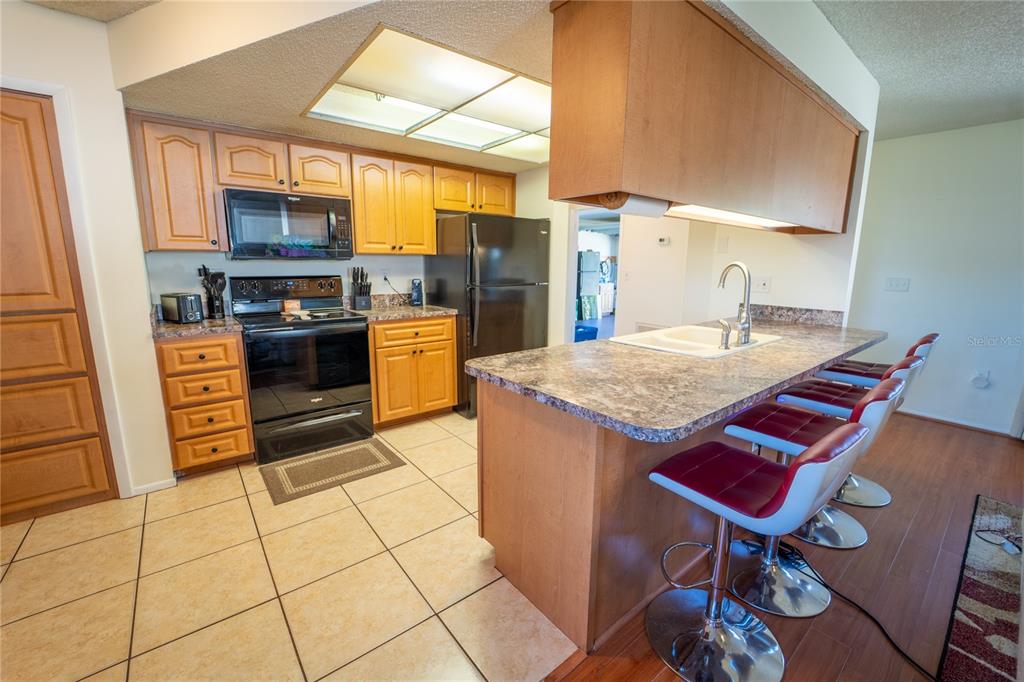 1394 Escobar Avenue Spring Hill, FL 34608 - Photo 13 of 47 a kitchen with a stove a sink and a refrigerator