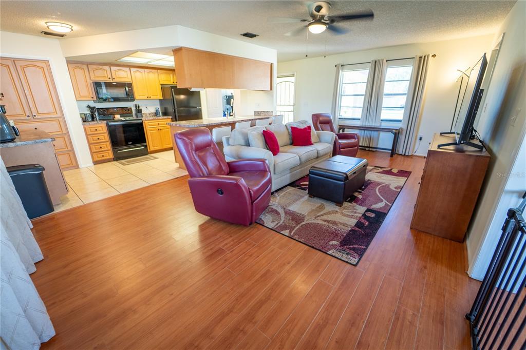 1394 Escobar Avenue Spring Hill, FL 34608 - Photo 16 of 47 a living room with furniture fireplace and flat screen tv