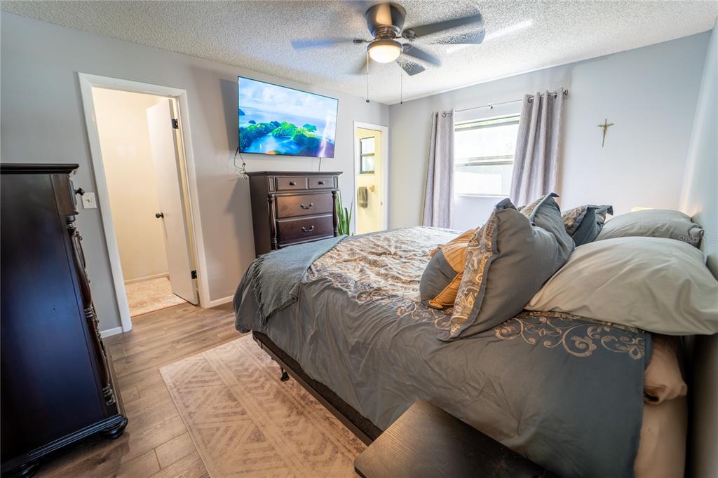 1394 Escobar Avenue Spring Hill, FL 34608 - Photo 19 of 47 a bedroom with a bed and a flat screen tv