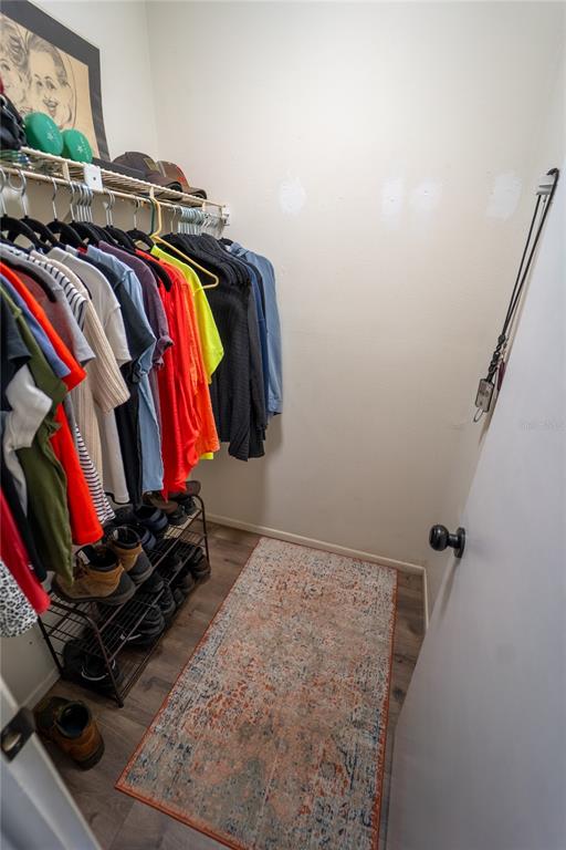 1394 Escobar Avenue Spring Hill, FL 34608 - Photo 22 of 47 a view of walk in closet with clothes and shoes
