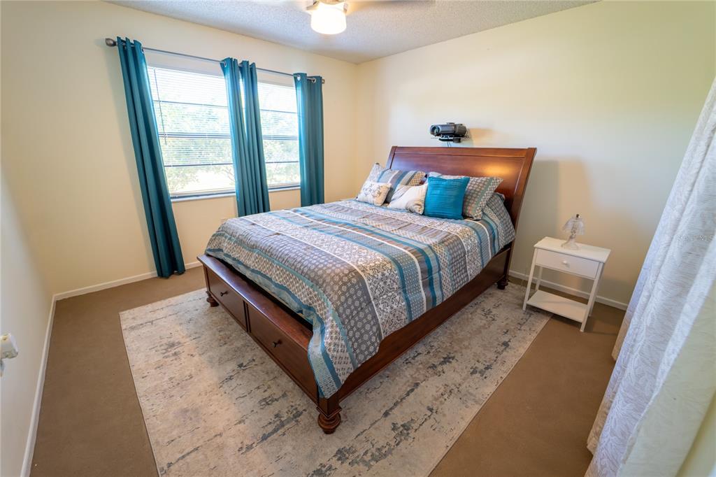 1394 Escobar Avenue Spring Hill, FL 34608 - Photo 23 of 47 a bedroom with a bed and wooden floor