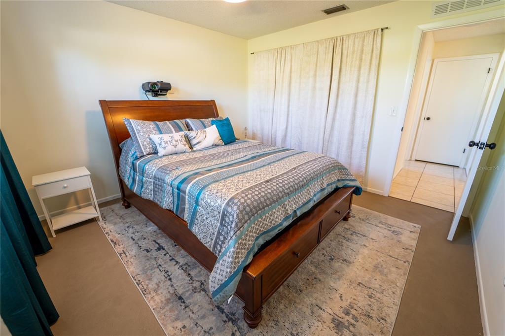 1394 Escobar Avenue Spring Hill, FL 34608 - Photo 24 of 47 a bedroom with a bed and wooden floor