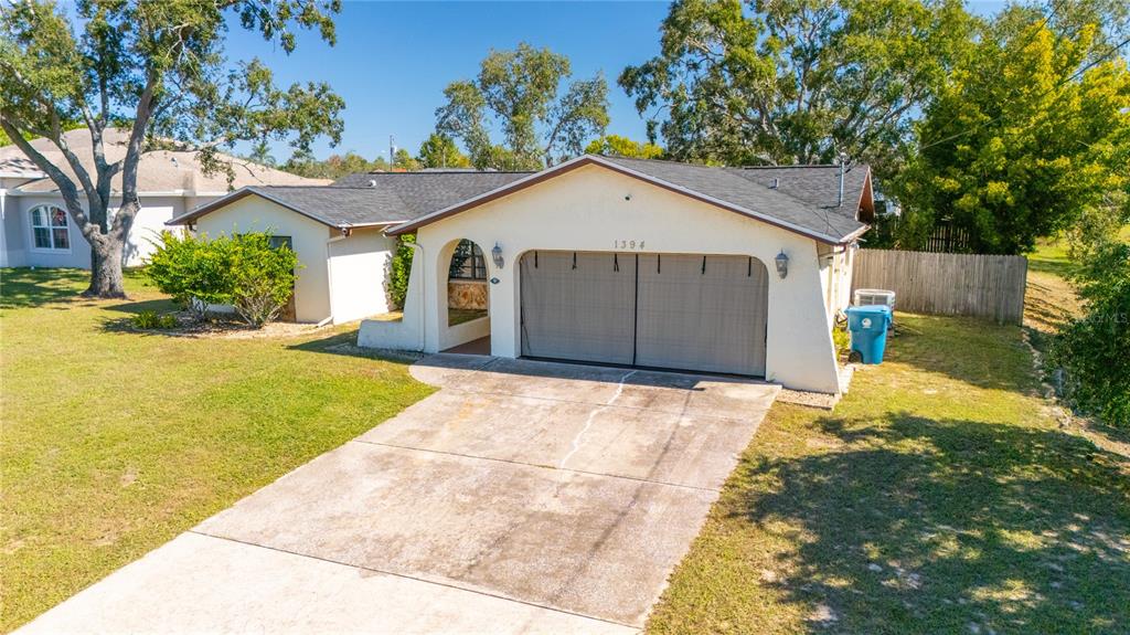 1394 Escobar Avenue Spring Hill, FL 34608 - Photo 3 of 47 a view of outdoor space yard and garage
