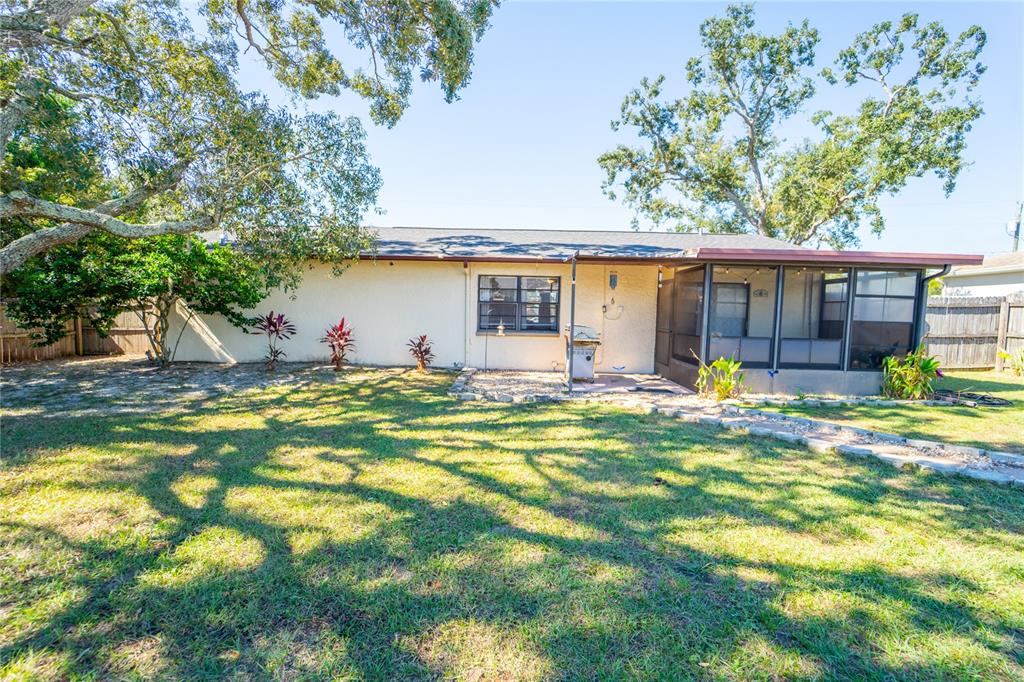 1394 Escobar Avenue Spring Hill, FL 34608 - Photo 34 of 47 a view of a house with pool and a tree