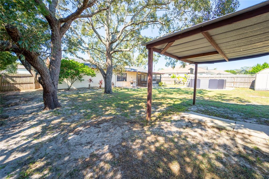 1394 Escobar Avenue Spring Hill, FL 34608 - Photo 36 of 47 a view of a backyard with a tree