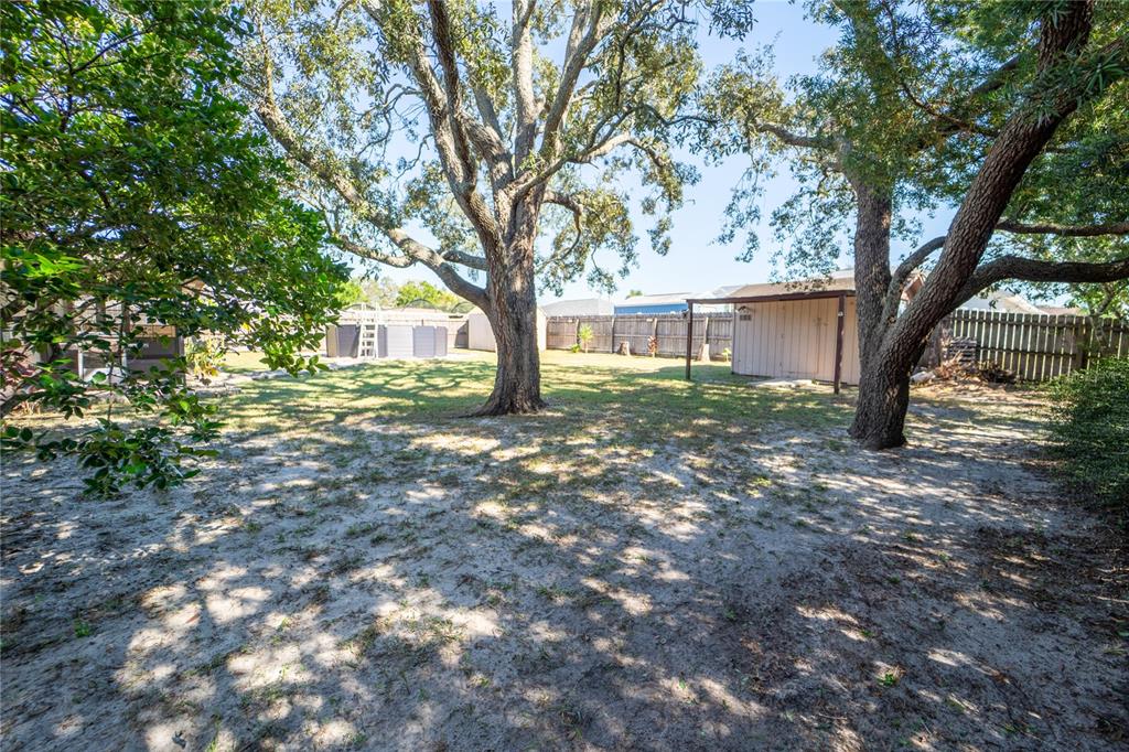 1394 Escobar Avenue Spring Hill, FL 34608 - Photo 37 of 47 a view of house with outdoor space and trees