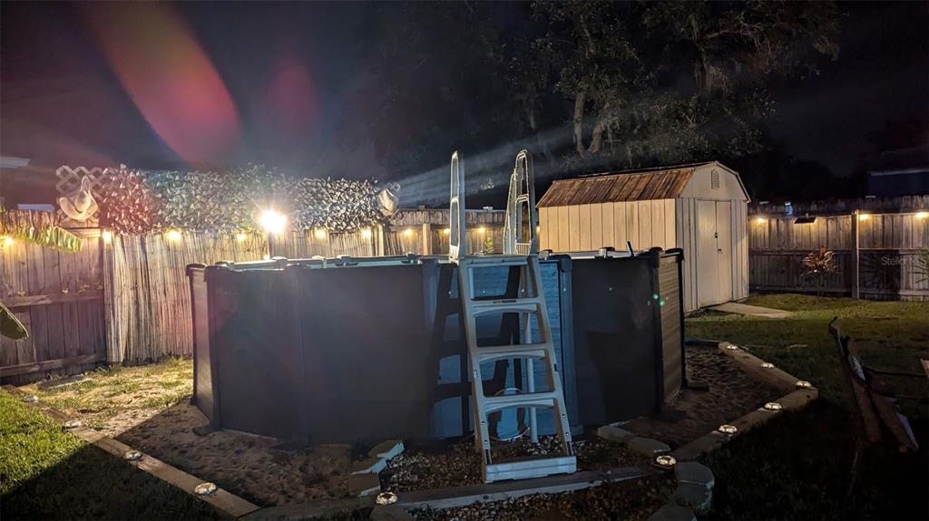 1394 Escobar Avenue Spring Hill, FL 34608 - Photo 39 of 47 a view of a house with backyard and sitting area