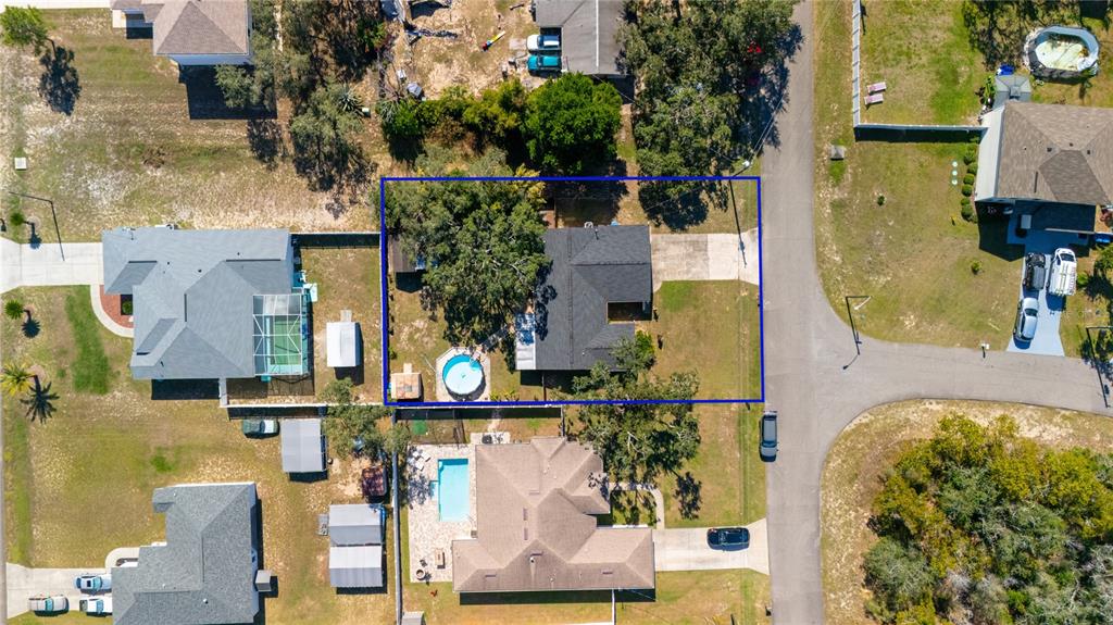 1394 Escobar Avenue Spring Hill, FL 34608 - Photo 6 of 47 aerial view of multiple houses with a swimming pool
