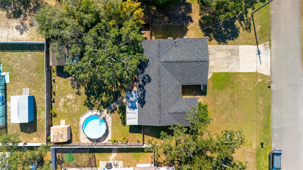 1394 Escobar Avenue Spring Hill, FL 34608 - Photo 8 of 47 an aerial view of a house with garden space and a fountain