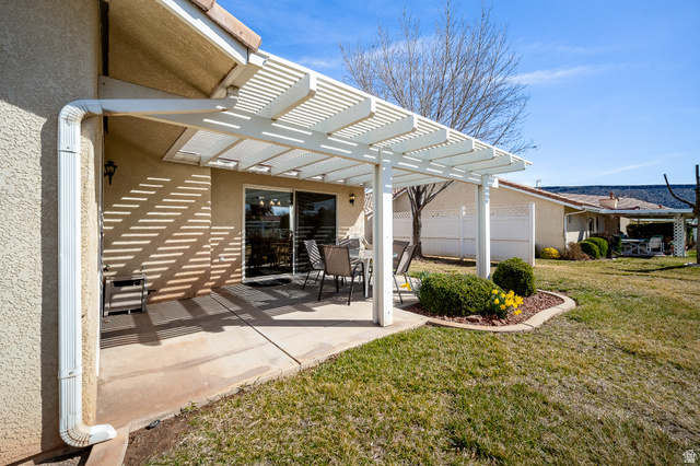 1825 West Mathis Park Place, Unit 46 St. George, UT 84770 - Photo 39 of 45 Rear view of property with a pergola, stucco siding, and a patio area