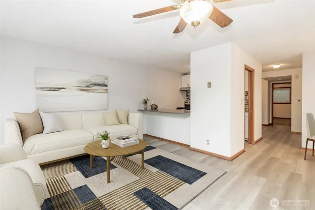 a living room with furniture and wooden floor