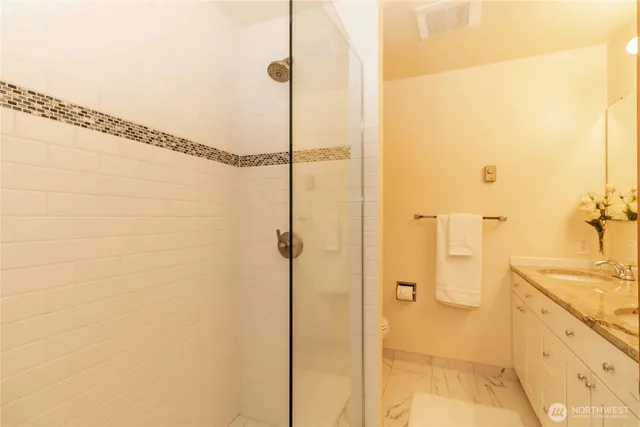 a bathroom with a shower and a sink