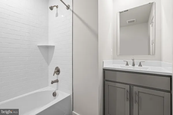 a bathroom with a sink and mirror