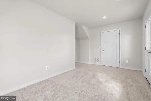 an empty room with windows and closet
