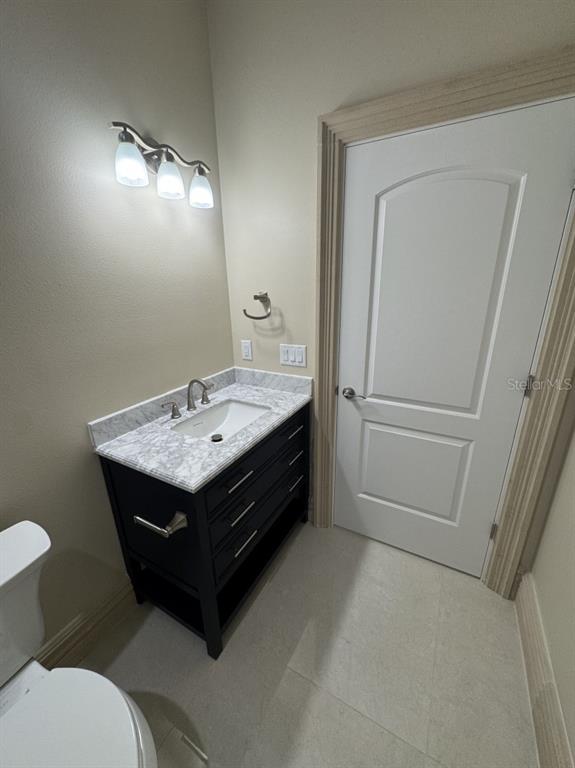 8351 Southwest 14th Lane Okeechobee, FL 34974 - Photo 17 of 46 a spacious bathroom with a sink a toilet and a mirror