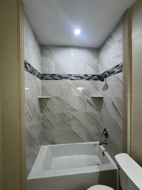 8351 Southwest 14th Lane Okeechobee, FL 34974 - Photo 25 of 46 a bathroom with a bathtub and a shower