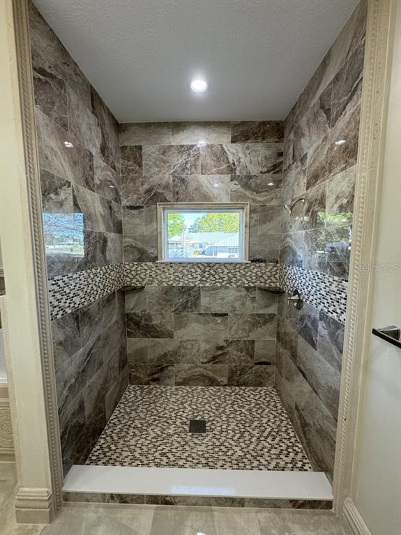 8351 Southwest 14th Lane Okeechobee, FL 34974 - Photo 26 of 46 a bathroom with a granite countertop window and a rug