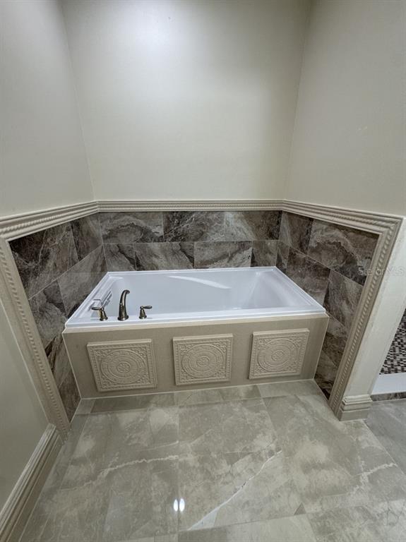 8351 Southwest 14th Lane Okeechobee, FL 34974 - Photo 28 of 46 a white bath tub sitting in a bathroom