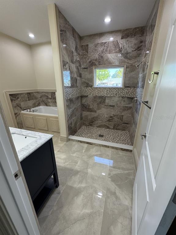 8351 Southwest 14th Lane Okeechobee, FL 34974 - Photo 30 of 46 a bathroom with a granite countertop sink a large mirror and shower