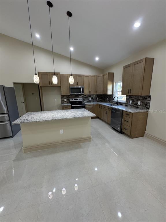 8351 Southwest 14th Lane Okeechobee, FL 34974 - Photo 42 of 46 a large kitchen with a large counter top appliances and a wooden floor