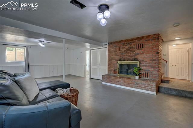 4665 Fox Road Cascade, CO 80809 - Photo 38 of 50 The finished Garden-Level Basement features painted concrete floors and a spacious Family/Rec Room with a wood-burning fireplace.