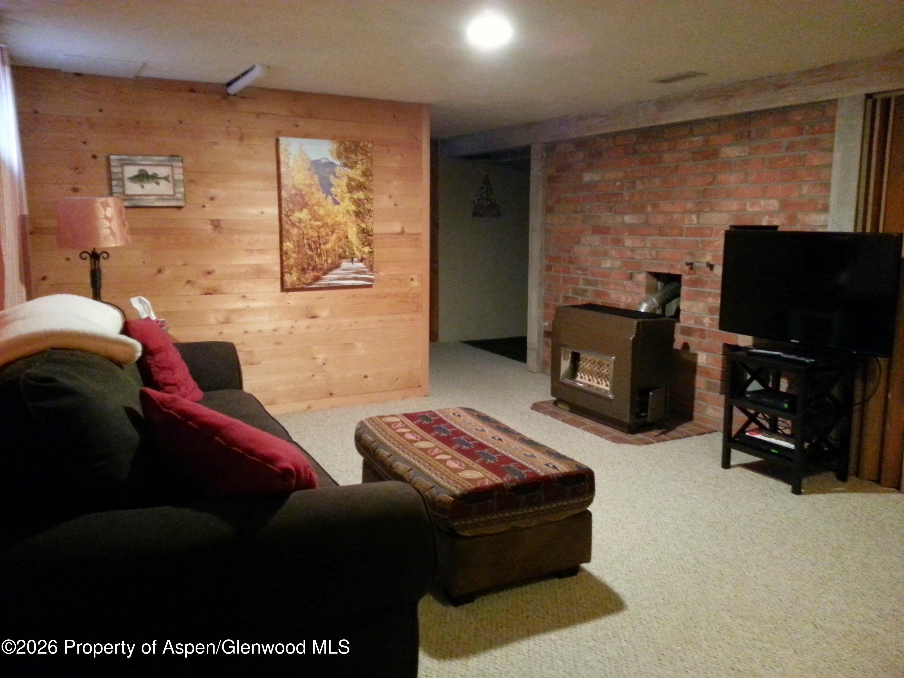 262 Midland Avenue Basalt, CO 81621 - Photo 10 of 10 a living room with furniture a flat screen tv and a fireplace