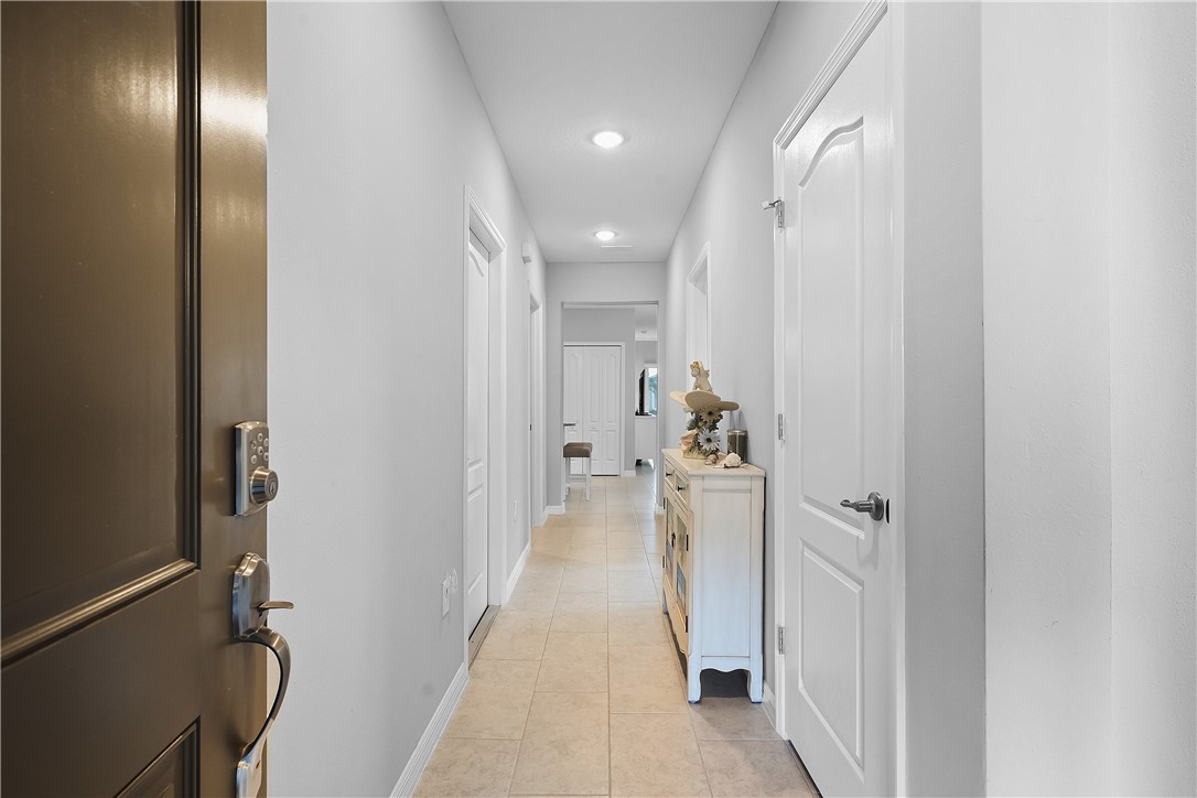 6187 Red Maple Manor Vero Beach, FL 32966 - Photo 3 of 31 a view of a hallway with a livingroom and a bathroom