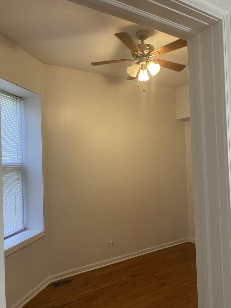 6424 South Morgan Street, Unit 1 Chicago, IL 60621 - Photo 5 of 7 a view of a small space with wooden floor and a window