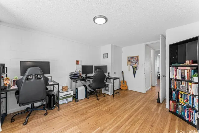 a view of a workspace with furniture and bookshelf